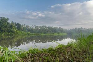 A beutiful scenery of landscape with river, sky in village in kerala, india photo