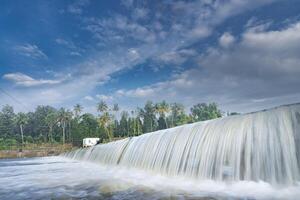 A beautiful view of a waterfall from a check dam In Kerala, India. photo