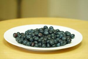 closeup view of Blueberries in a plate on the table photo