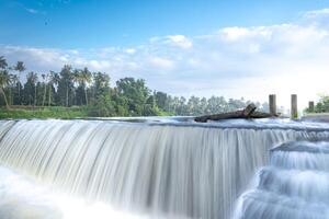 A beautiful view of a waterfall from a check dam In Kerala, India. photo