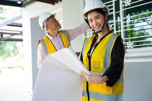 Senior home inspector checking home defects and teaching young engineers, before handing it over to client. Young engineers learn home inspection with Senior, Real estate, and renovation concepts. photo