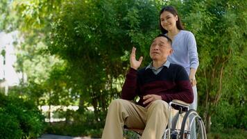 A daughter taking care of the patient in a wheelchair and talk with mom. Concept of happy retirement with care from a caregiver and Savings and senior health insurance, Happy family and retirement photo