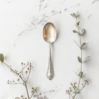 AI generated minimalistic style silver spoon on white background top view photo