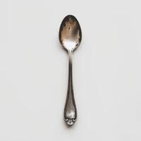 AI generated minimalistic style silver spoon on white background top view photo