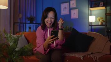 Excited adult woman use mobile phone browsing online say wow yes, found out great big win at home video