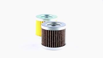 Engine oil filters of used and unused yellow and black motor oil filters rotate on a white background video