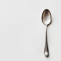 AI generated minimalistic style silver spoon on white background top view photo