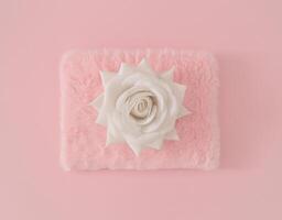 White colored rose on pastel pink and faux fur background. Minimal aesthetic layout. Romantic creative idea. Spring and summer fashion concept with blooming flower. Flat lay. photo