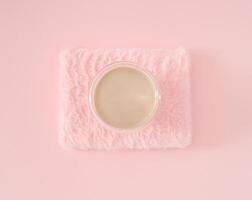 Trendy arrangement of cup of coffee on light pastel pink faux fur background. Minimal coffee concept. Creative fancy coffee idea. Pink flat lay composition. photo