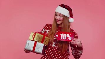 Woman in Christmas sweater showing gift box and 10 Percent discount inscriptions banner text note video