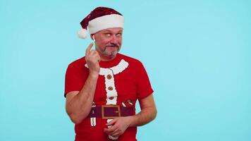 Man in Christmas t-shirt listening music via earphones, dancing disco fooling around having fun video