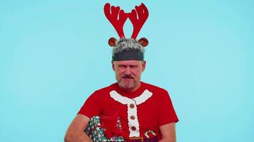 Upset angry man in Christmas deer antlers raising hands in indignant expression, quarreling conflict video