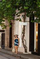 Beautiful woman wearing the traditional Colombian hat called Sombrero Vueltiao at the historical streets of the Cartagena de Indias walled city photo