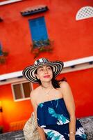 Beautiful woman wearing the traditional Colombian hat called Sombrero Vueltiao at the historical streets of the Cartagena de Indias walled city photo