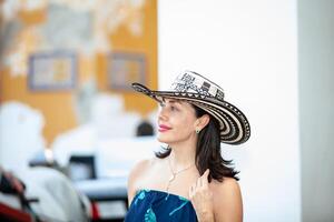 Beautiful woman wearing the traditional Colombian hat called Sombrero Vueltiao at the Customs Square on the historical streets of the Cartagena de Indias walled city photo