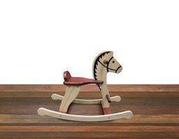 Rocking horse on wooden floor Isolated on a white background photo