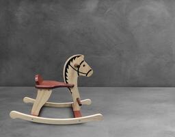 wooden rocking horse on cement floor photo