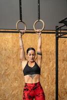 Women training olympic ring in cross training room photo