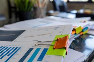 The pile of documents on the secretary's desk was prepared for the executives who would be attending the meeting. Several documents were stacked on the secretary's desk ready for the attendees. photo