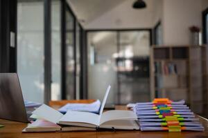 The pile of documents on the secretary's desk was prepared for the executives who would be attending the meeting. Several documents were stacked on the secretary's desk ready for the attendees. photo