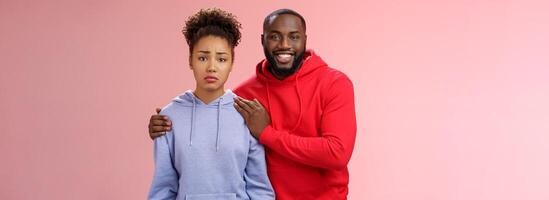 Girl unwilling participate event feel nervous insecure boyfriend encouraging hugging boost confidense assuring everything alright smiling self-assured promise everything be okay, pink background photo