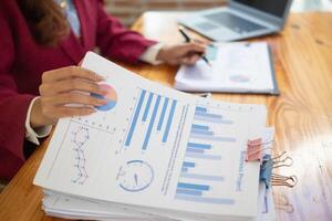 secretary is searching through pile of important documents on office table deliver them to manager for presentation in time at meeting. Concept of difficulty finding information from piles of document photo