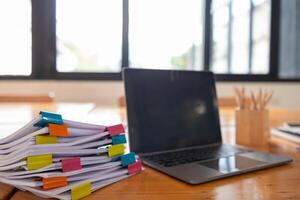 The pile of documents on the secretary's desk was prepared for the executives who would be attending the meeting. Several documents were stacked on the secretary's desk ready for the attendees. photo