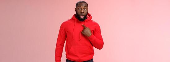 Shocked guy cannot believe he chosen drop jaw widen eyes staring camera speechless pointing himself impressed cannot believe picked do important task, standing stunned pink background photo