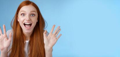 Excited charismatic happy lively redhead young funny woman smiling thrilled open mouth fascinated wide eyes surprised staring adore cool new product raise palms waving hello, show ten dozen photo