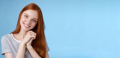 Romantic tender lovely redhead girlfriend tilting head press palms together smiling touched look sympathy check out cute picture friend standing delighted amused, heartwarming moment photo