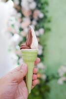 Ice cream cone in hand, close-up. Selective focus. photo