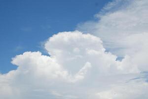 Blue sky background with tiny clouds photo