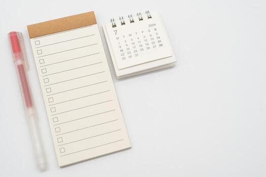 Blank Check list or Empty small notepad with checkbox and Simple desk calendar for JULY 2024. Blank checklist for text. Copy Space. photo