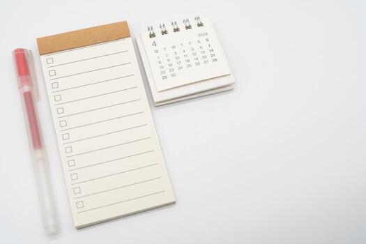 Blank Check list or Empty small notepad with checkbox and Simple desk calendar for APRIL 2024. Blank checklist for text. Copy Space. photo