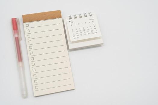 Blank Check list or Empty small notepad with checkbox and Simple desk calendar for DECEMBER 2024. Blank checklist for text. Copy Space. photo