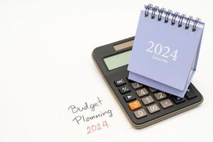 Budget Planning 2024 text message by hand writing on paper note and Calendar 2024. Budget planning concept. isolated on white background. photo