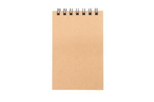 Spiral notepad isolated on white background with clipping path. Blank one face brown paper note. empty sheet of brown paper. photo