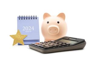 Financial, plan for money saving. Piggy bank, Calculator and 2024 desk calendar isolated on white background. Goals, Plan, Action, Money Saving, Retirement fund, Pension, Investment concept. photo