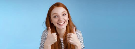 Nice idea keep up. Supportive tender cute european ginger girl blue eyes cheering friend boost mood show thumbs up smiling approval like good choice, agree interesting suggestion, satisfied photo