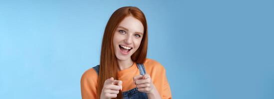 My congrats. Sassy confident enthusiastic young attractive ginger girl blue eyes pointing finger pistols camera smiling broadly cheering friend did great job congratulate you awesome performance photo