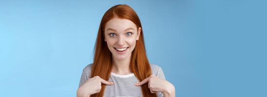 Surprised glad impressed excited redhead girl blue eyes stare camera fascinated cannot believe win pointing herself questioned amused getting nominated first place, picked receive scholarship photo