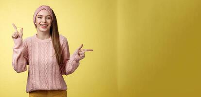 Pick what want. Charismatic cheerful young female student in headband, sweater pointing up, indicating right smiling cute, promoting advertisement showing opportunities and choices over white wall photo