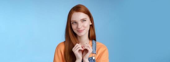 Devious tricky young girl have excellent plan smirking delighted mysteriously look upper left corner smiling have idea thoughtfully twiddles fingers standing rejoicing blue background photo