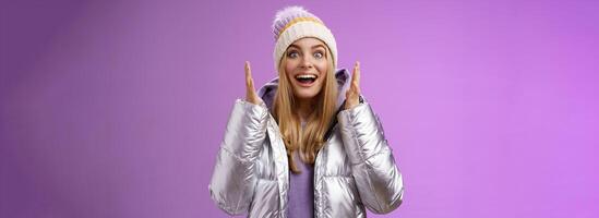 Impressed fascinated speechless attractive blond girl explaining awesome situation shaking hands excited smiling gasping happily widen eyes surprised, standing purple background amused photo