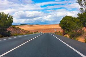 Asphalt road in the countryside of Tarragona, Spain photo