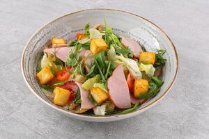 squash salad and halloumi cheese with sesame seeds against a stone background, studio food photo 1