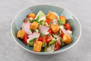 squash salad and halloumi cheese with sesame seeds against a stone background, studio food photo 2