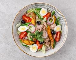 salad with tuna, quail egg and olives studio food photo 2