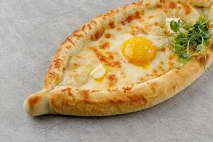 khachapuri in Adjarian style on a stone background studio food photo 4