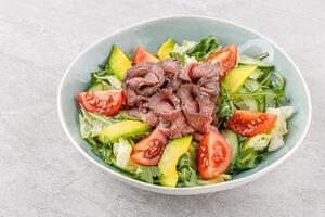 Salad with roast beef, avocado and tomatoes on a stone background studio food photo 9